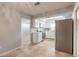 Open-concept view of the kitchen featuring white cabinets, stainless steel appliances, and flowing tile flooring at 1617 Tuscaloosa Ave, Daytona Beach, FL 32117