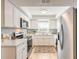 Well-lit kitchen featuring white cabinets, stainless steel appliances, and neutral countertops providing modern elegance at 1617 Tuscaloosa Ave, Daytona Beach, FL 32117