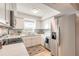 Bright kitchen featuring white cabinets, stainless steel appliances, and tile flooring for easy maintenance at 1617 Tuscaloosa Ave, Daytona Beach, FL 32117