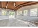 Open concept living room with wood ceiling, ample windows bringing in natural light and tile floors at 1617 Tuscaloosa Ave, Daytona Beach, FL 32117