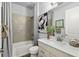 Well-lit bathroom with a tiled shower, modern vanity, and stylish decorative accents at 165 Azure Mist Way, Daytona Beach, FL 32124