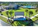 View of community resident's center surrounded by lush green grass and palm trees at 165 Azure Mist Way, Daytona Beach, FL 32124