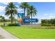 Mosaic community entrance sign amid lush landscaping with palm trees and green lawn at 165 Azure Mist Way, Daytona Beach, FL 32124