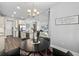 Charming dining area with an elegant chandelier, seamlessly connected to the kitchen and living spaces at 165 Azure Mist Way, Daytona Beach, FL 32124