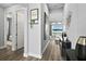 Inviting hallway with hardwood floors, decorative art, and view to the living area at 165 Azure Mist Way, Daytona Beach, FL 32124