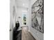 Inviting hallway with elegant decor, wood floors, and decorative light fixtures at 165 Azure Mist Way, Daytona Beach, FL 32124