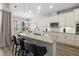 Gourmet kitchen with granite counters, island with seating, and stainless steel appliances at 165 Azure Mist Way, Daytona Beach, FL 32124