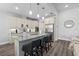 Modern kitchen with granite countertops, stainless steel appliances, a kitchen island with seating, and ample storage at 165 Azure Mist Way, Daytona Beach, FL 32124