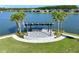 Aerial view of the community lakefront stage surrounded by palm trees at 165 Azure Mist Way, Daytona Beach, FL 32124