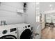 A bright laundry area connects to the kitchen with modern appliances and storage at 165 Azure Mist Way, Daytona Beach, FL 32124