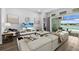 Comfortable living room with modern decor, a large TV, and sliding glass doors to the patio and lake at 165 Azure Mist Way, Daytona Beach, FL 32124