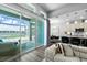 Open living room with lake view, seamless access to the pool, and modern kitchen at 165 Azure Mist Way, Daytona Beach, FL 32124