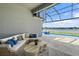 Relaxing outdoor lounge area with a private pool overlooking a tranquil lake and lush landscape at 165 Azure Mist Way, Daytona Beach, FL 32124