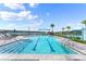 Resort-style pool with clear blue water and inviting lounge areas and tropical landscaping at 165 Azure Mist Way, Daytona Beach, FL 32124