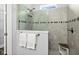 Tiled shower with frameless glass door, rainfall showerhead, and built-in seat at 165 Azure Mist Way, Daytona Beach, FL 32124