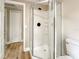 Bathroom featuring a glass shower, toilet, and view of a door to a bedroom at 165 S Massachusetts Ave, Deland, FL 32724