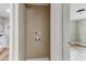 Bathroom featuring a vanity with a round mirror and a view of a laundry room at 165 S Massachusetts Ave, Deland, FL 32724