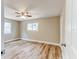 This bedroom includes a ceiling fan and light-wood flooring at 165 S Massachusetts Ave, Deland, FL 32724