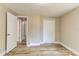 Bedroom with wood-look floors, white trim and multiple access doors at 165 S Massachusetts Ave, Deland, FL 32724