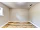 Bright bedroom with light wood flooring and fresh, neutral paint at 165 S Massachusetts Ave, Deland, FL 32724