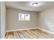 Bright bedroom features neutral walls, a window, and beautiful, new vinyl flooring at 165 S Massachusetts Ave, Deland, FL 32724