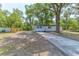 Property featuring a long driveway, fresh exterior paint, and well-maintained front yard at 165 S Massachusetts Ave, Deland, FL 32724