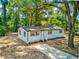 Charming single-story home boasts a fresh exterior with white siding and a well-manicured front yard at 165 S Massachusetts Ave, Deland, FL 32724