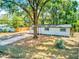 This home has an inviting exterior with a well-manicured lawn and a spacious driveway at 165 S Massachusetts Ave, Deland, FL 32724