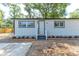 Charming home with manicured flowerbeds flanking the entry at 165 S Massachusetts Ave, Deland, FL 32724
