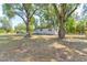 View of house featuring mature trees and landscaping at 165 S Massachusetts Ave, Deland, FL 32724