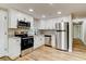 Well-equipped kitchen featuring stainless steel appliances, granite countertops, and modern fixtures at 165 S Massachusetts Ave, Deland, FL 32724
