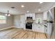 Bright kitchen with stainless steel appliances, granite countertops, and hardwood floors at 165 S Massachusetts Ave, Deland, FL 32724