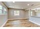 Spacious living room with updated hardwood floors and neutral color at 165 S Massachusetts Ave, Deland, FL 32724