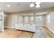 An open concept living and dining area with a breakfast bar and hardwood floors at 165 S Massachusetts Ave, Deland, FL 32724