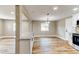 Open concept living and dining area with hardwood floors, breakfast bar, and recessed lighting at 165 S Massachusetts Ave, Deland, FL 32724