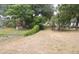 View of the chain link fenced in backyard with shed, playset and mature trees at 1714 Urbana Ave, Deltona, FL 32725
