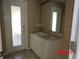 Bathroom featuring white cabinets, a sink, and a walk-in shower at 1714 Urbana Ave, Deltona, FL 32725