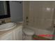 Bathroom featuring a toilet, sink with white cabinets, and a shower with tile surround at 1714 Urbana Ave, Deltona, FL 32725