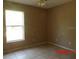 The empty bedroom has a tile floor and a single window at 1714 Urbana Ave, Deltona, FL 32725