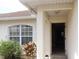 Inviting home entrance featuring a covered doorway and large window at 1714 Urbana Ave, Deltona, FL 32725