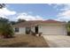 Charming single-story home with a well-maintained lawn and a spacious two-car garage at 1714 Urbana Ave, Deltona, FL 32725