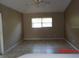 The living room has tile flooring and a window bringing natural light at 1714 Urbana Ave, Deltona, FL 32725