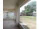 View of the tile patio to the backyard with shed, playset and mature trees at 1714 Urbana Ave, Deltona, FL 32725