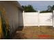 View of a partially fenced side yard with dry lawn at 1714 Urbana Ave, Deltona, FL 32725