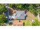 An aerial view reveals the home's roof, driveway, and the surrounding trees at 1738 Palm Rd, Ormond Beach, FL 32174