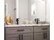 Bathroom featuring double sinks with marble countertops and modern fixtures at 1738 Palm Rd, Ormond Beach, FL 32174