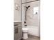 Bathroom with a marble-tiled shower, toilet, vanity, and black fixtures at 1738 Palm Rd, Ormond Beach, FL 32174
