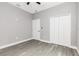 Bedroom featuring light gray walls, ceiling fan, closet, and light gray flooring at 1738 Palm Rd, Ormond Beach, FL 32174