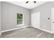 Bedroom featuring neutral gray walls, closet, and a window with natural lighting at 1738 Palm Rd, Ormond Beach, FL 32174
