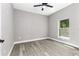 Bedroom showing light gray walls, ceiling fan, and a window with natural lighting at 1738 Palm Rd, Ormond Beach, FL 32174
